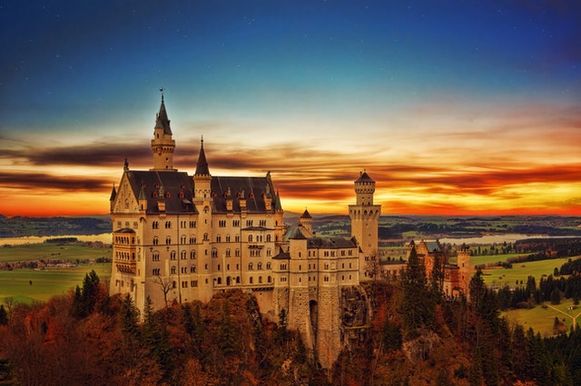 Castle on a hill with blue and orange sunset